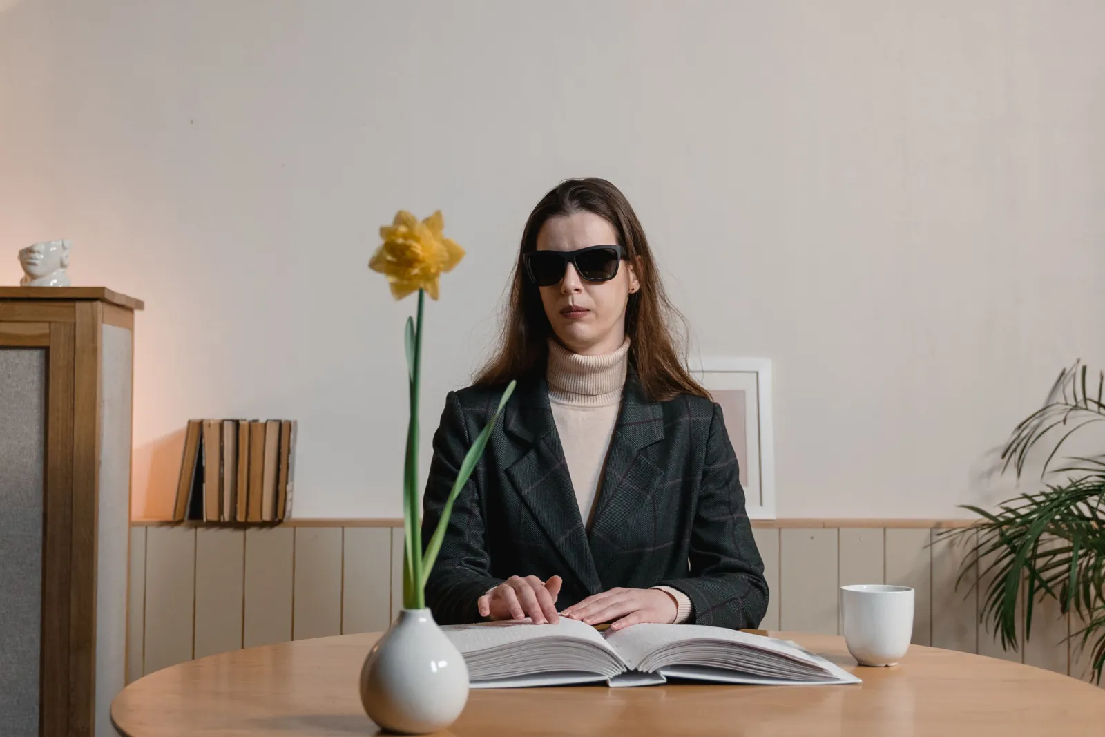 A professional woman reading a braille book