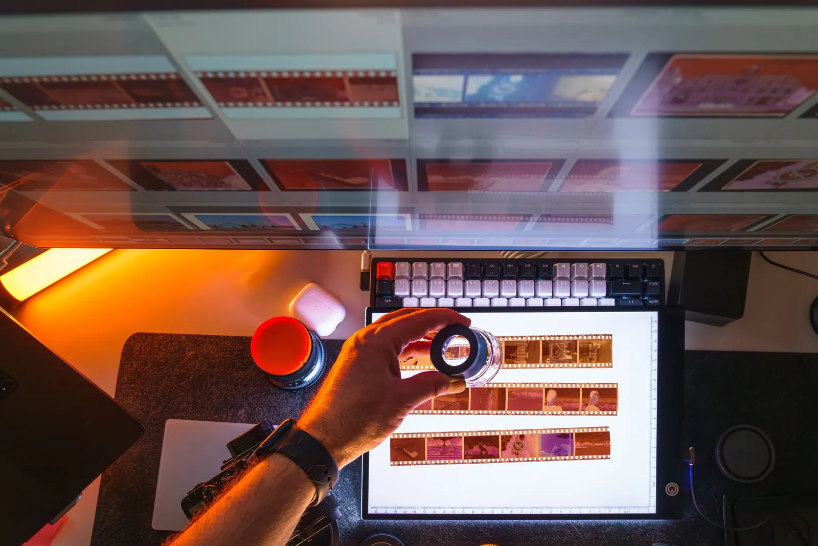 A loupe over film strips on a light table