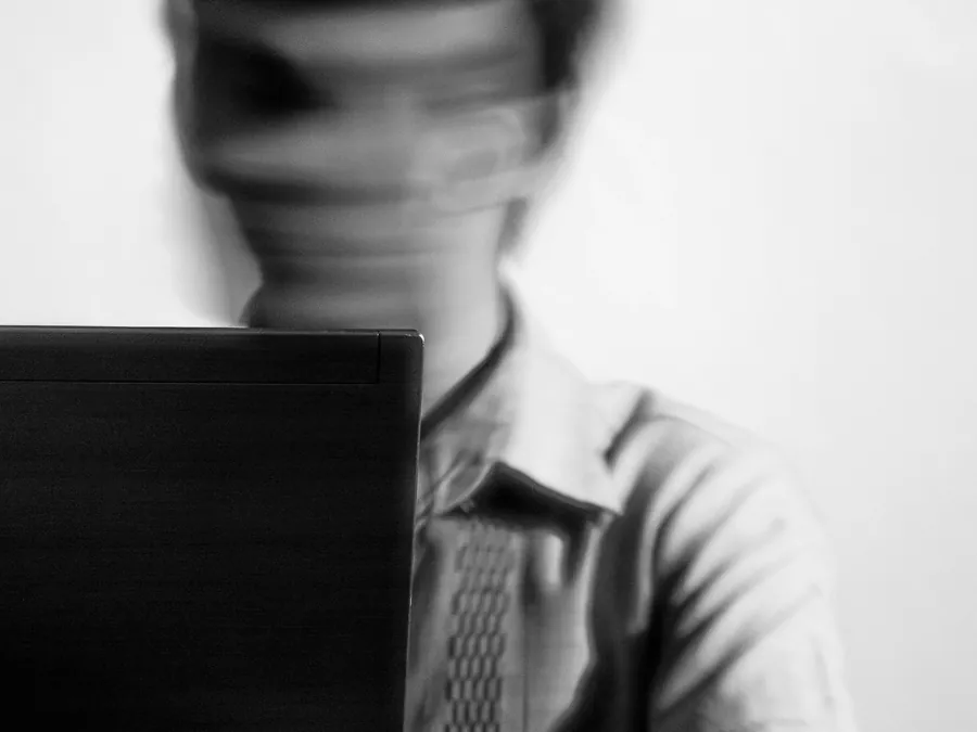 A person at a laptop in motion