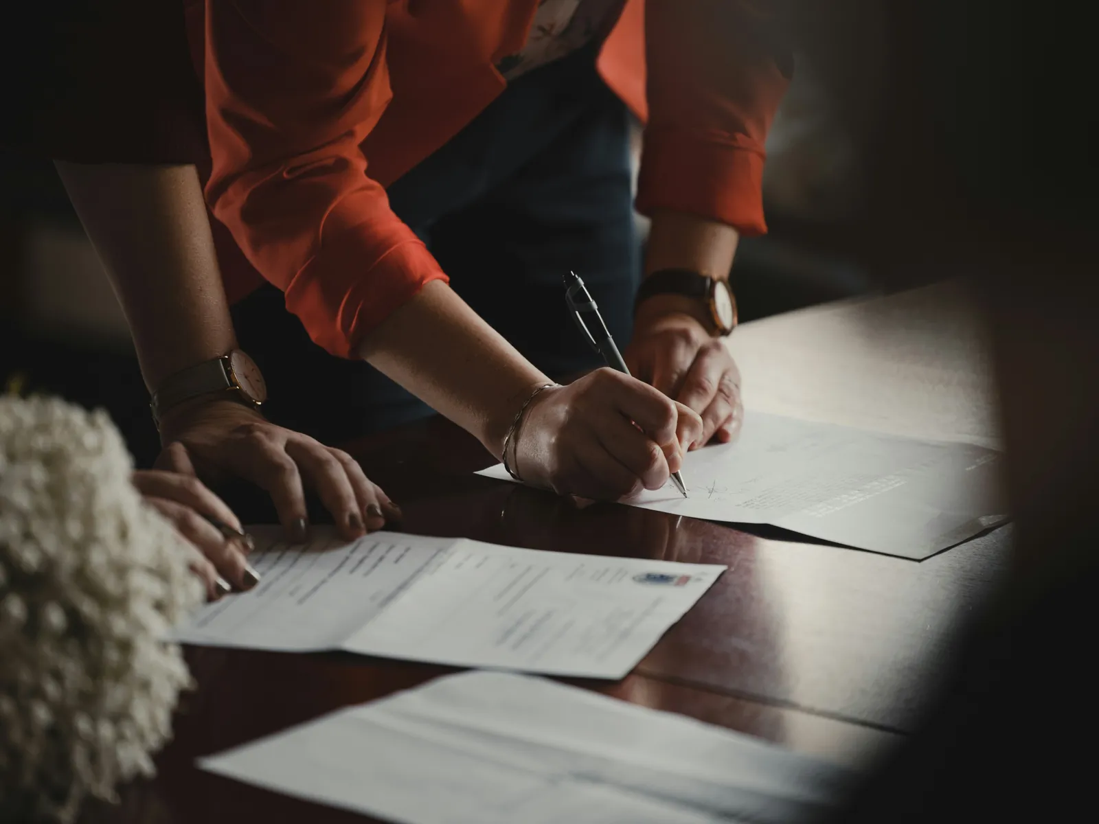 Two people signing a printed conformance report